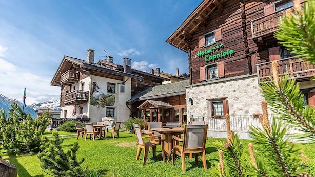 A traditional wooden building with a sign reading "Hotel Capriol." - Hotel Capriolo (Livigno)