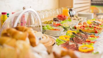 A buffet with various food items and beverages.