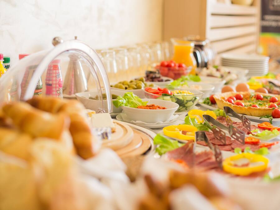 A buffet with various food items and beverages.