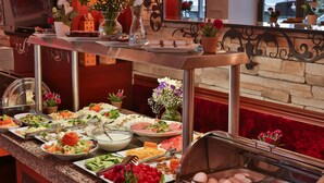 A buffet setup with various food items and a glass display case containing eggs. - Senatus Hotel - Special Class (Istanbul)