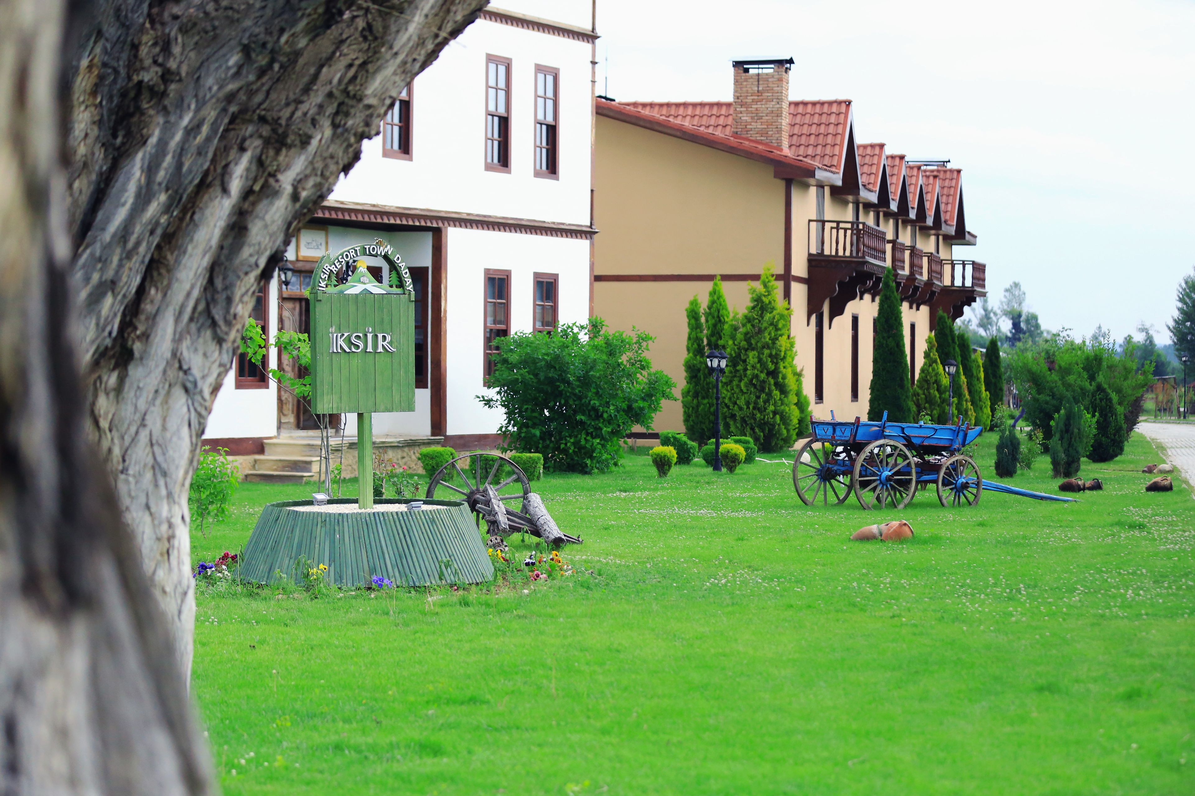 A building with a sign reading "KSIR" and a blue carriage in the foreground.