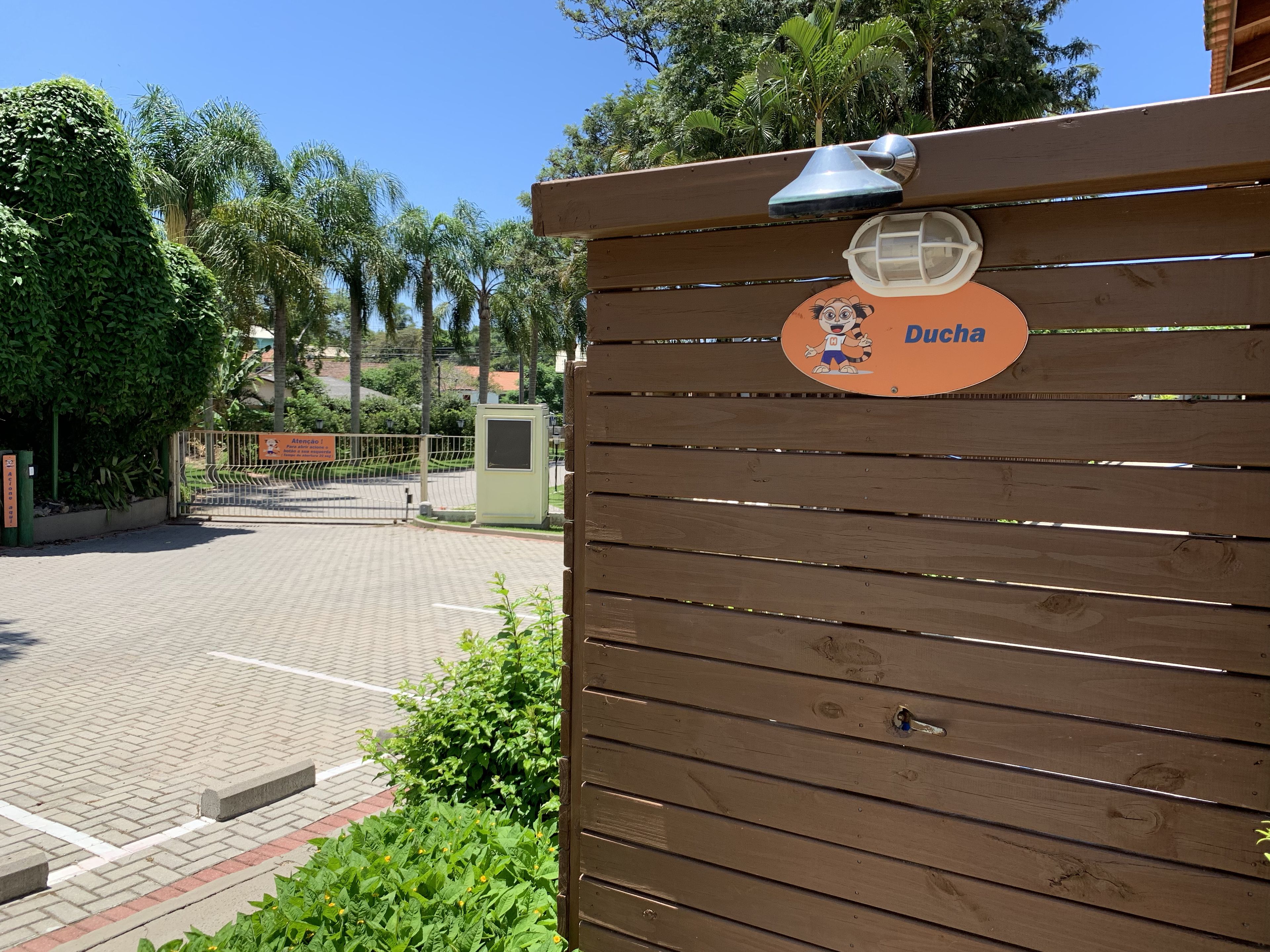 A wooden gate with a sign reading "Ducha" and a cartoon character.