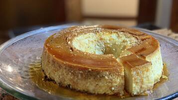 A caramel flan on a glass plate.
