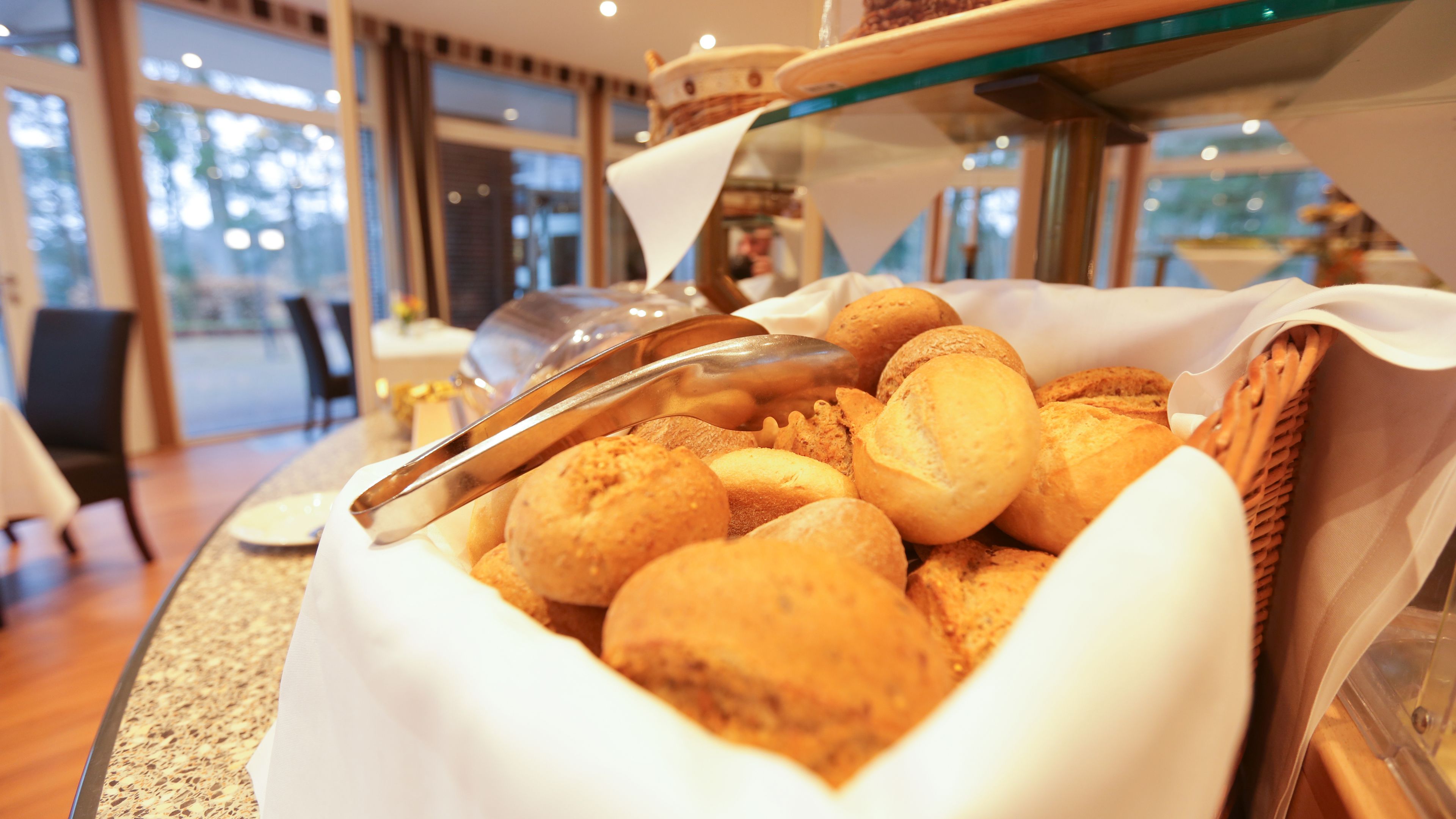 A buffet with a variety of bread and pastries.