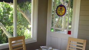 A dining area with a table set for four, including plates, cutlery, and cups.