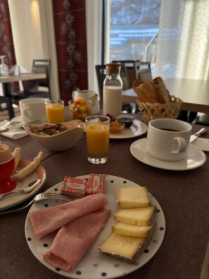 Enjoy a delicious breakfast for two in this inviting dining area, complete with a table set for a morning meal.