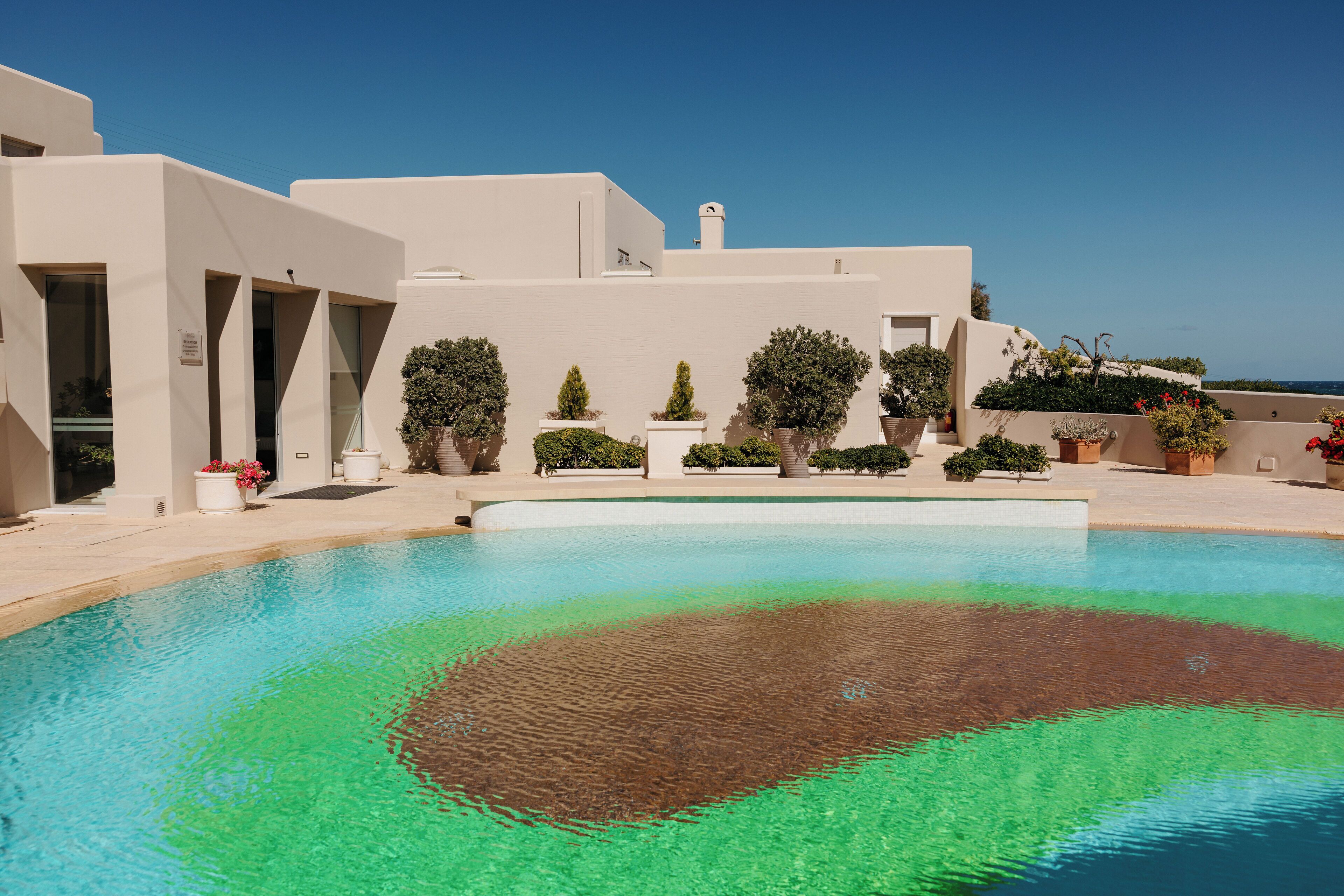 Una piscina al aire libre de temporada, sillones reclinables de piscina
