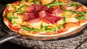 A pizza with various toppings on a pan.