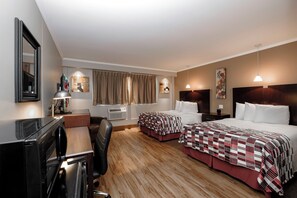 A hotel room with two beds, a desk, a chair, a TV, and a window with curtains. - Red Roof Inn & Suites Herkimer (Herkimer)