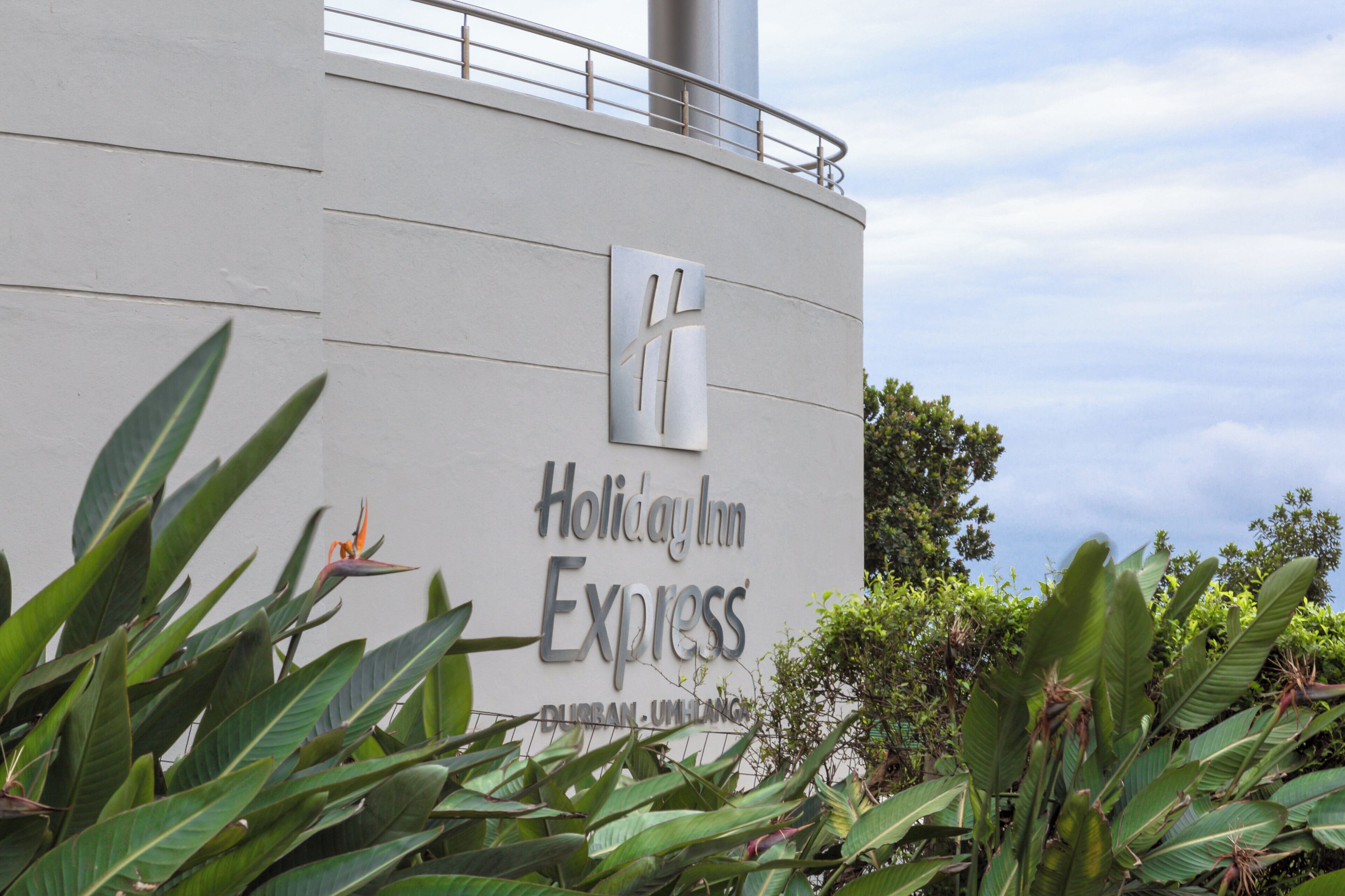 A building with a sign for 'Holiday Inn Express' and 'Durban, UH' indicating its location.
