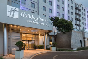 The exterior of the Holiday Inn Express in Durban-Umlanga, featuring a modern facade, large entrance, and prominent signage.