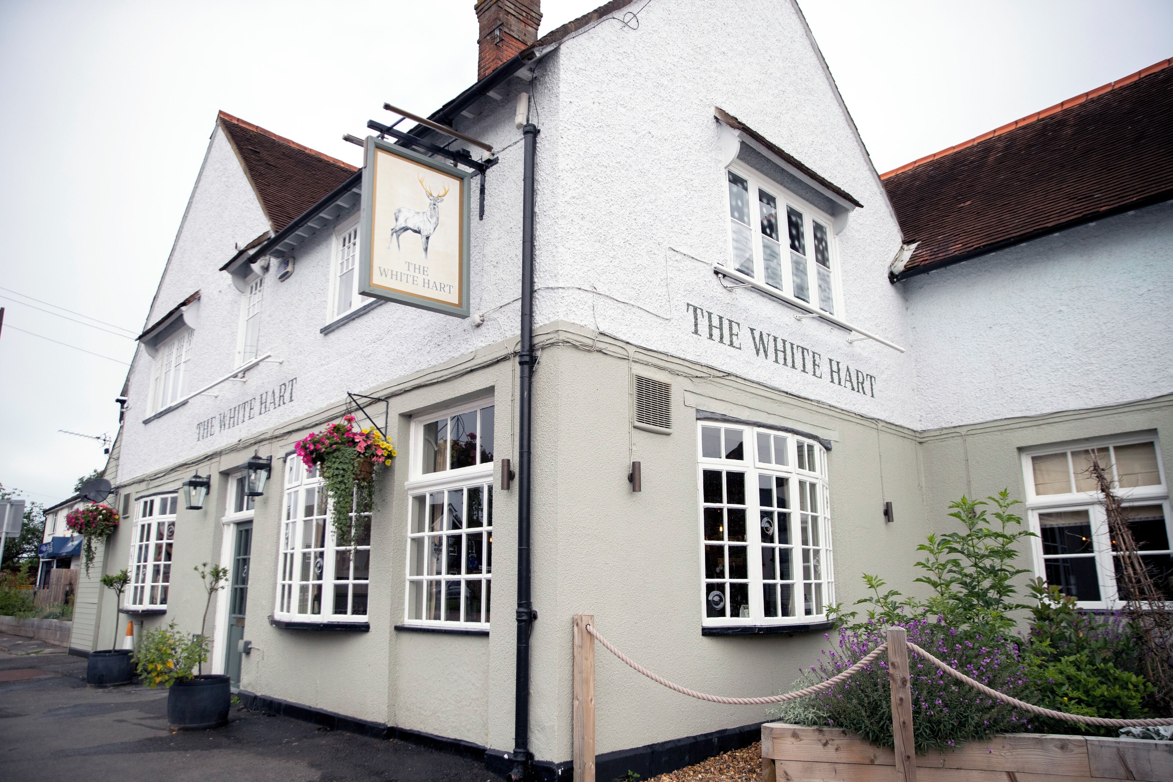 A traditional building with a sign reading "The White Hart."