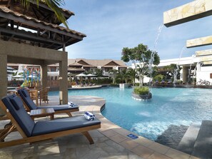 A pool area with lounge chairs, a water play structure, and a fountain. - Grand Lexis Port Dickson (Port Dickson)