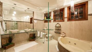 A modern bathroom with a glass-enclosed vanity, a freestanding bathtub, and a large mirror.