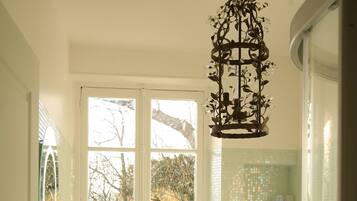 A bathroom with a freestanding bathtub, a sink, and a glass shower enclosure.