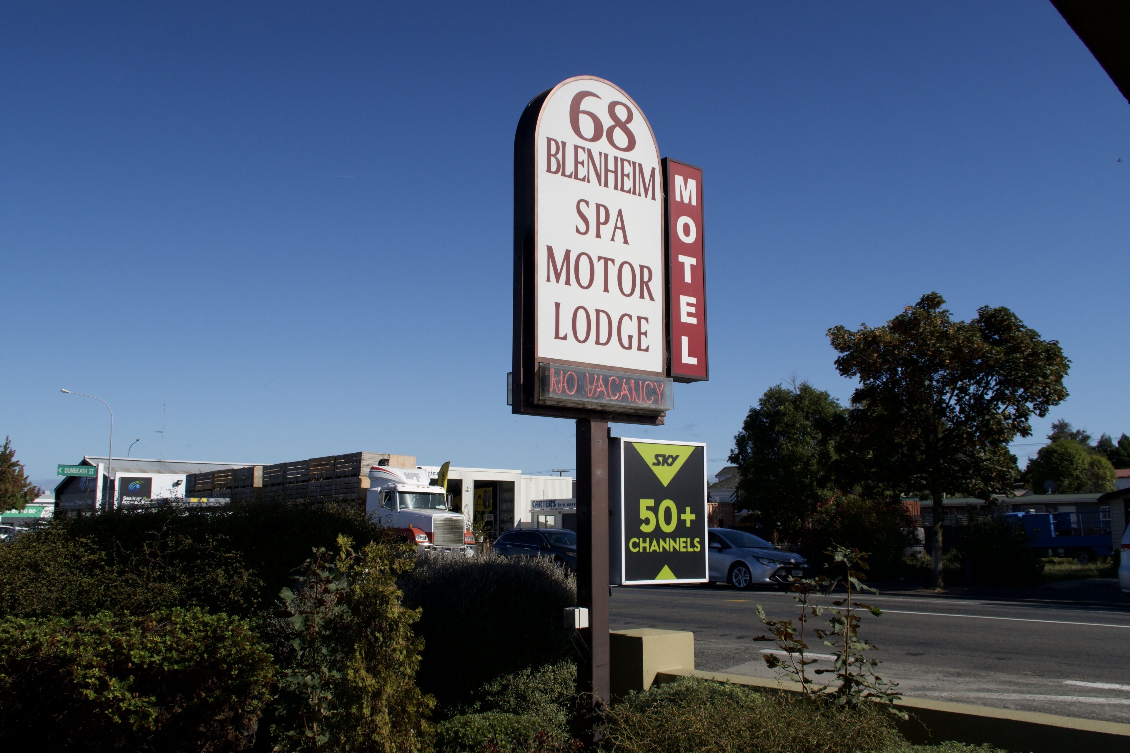 A motel sign with the name "68 Blenheim Spa Motor Lodge" and a "No Vacancy" sign below it.