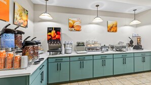 A breakfast bar with coffee machines, a fruit juice dispenser, and a variety of breakfast items. - Comfort Suites Gothenburg South (Gothenburg)