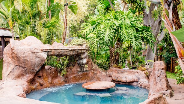 A pool with a rock formation and a circular hot tub. - 61 On Ireland (Polokwane)