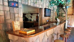 A bar area with a stone counter, stools, and a 'OPEN' sign. - 61 On Ireland (Polokwane)