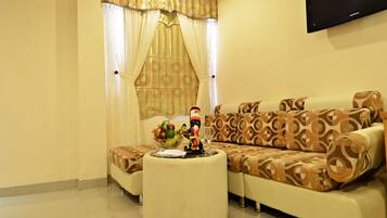 Relax in this inviting living room with a comfortable sofa set, flat-screen TV, and large window.