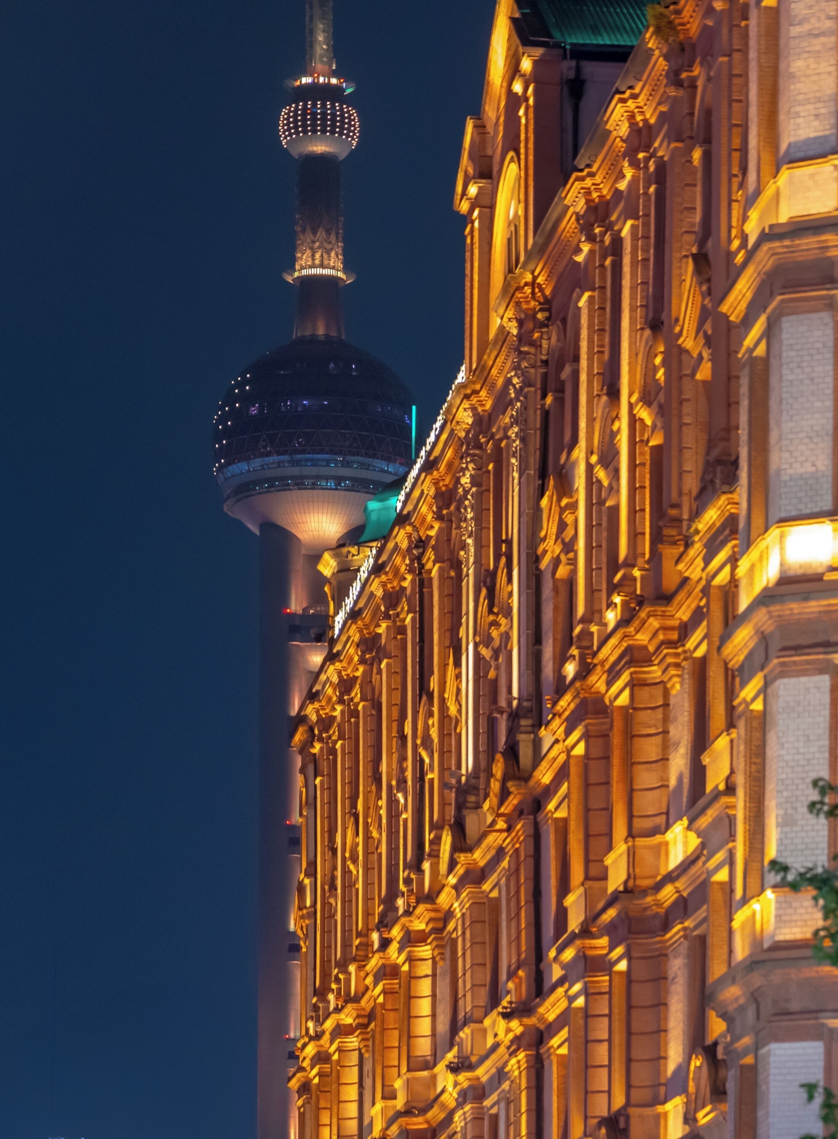 A building with ornate architectural details and a tower with illuminated rings.