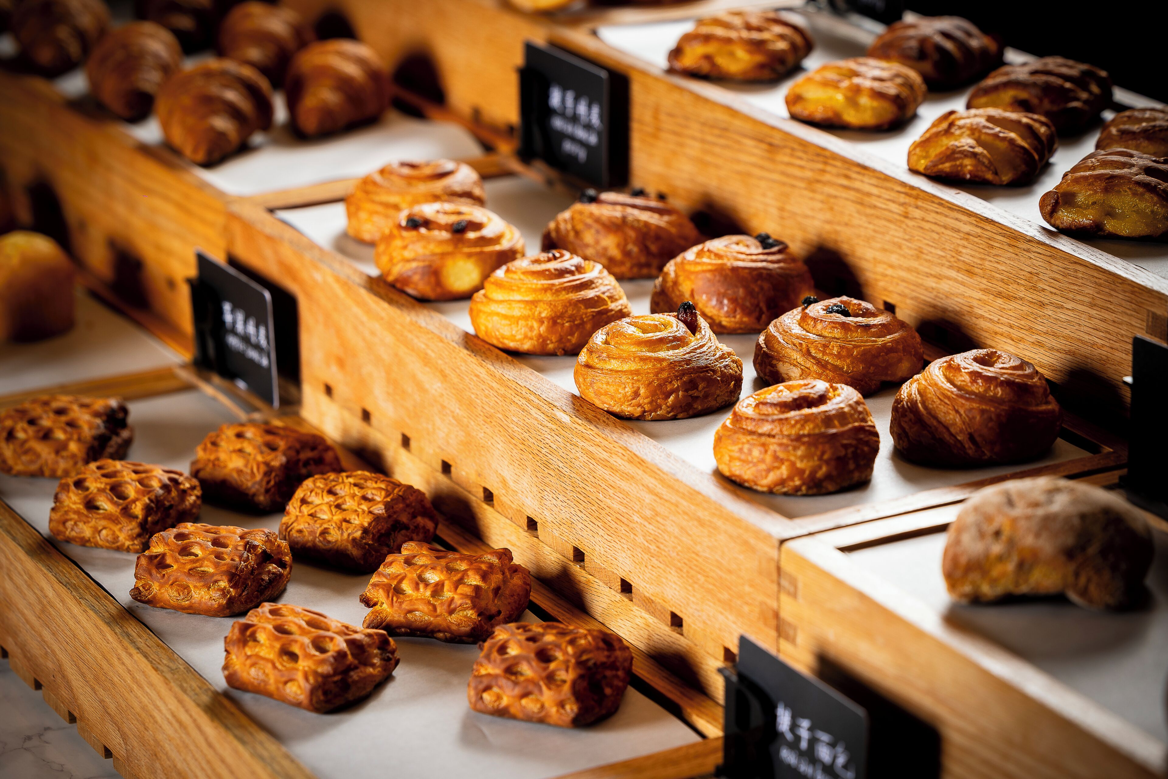 A bakery display with various baked goods.