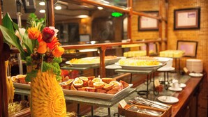 A buffet with various food items and a pineapple centerpiece.