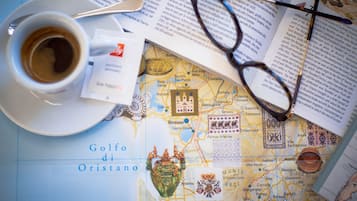 A map with a coffee cup and glasses on top.