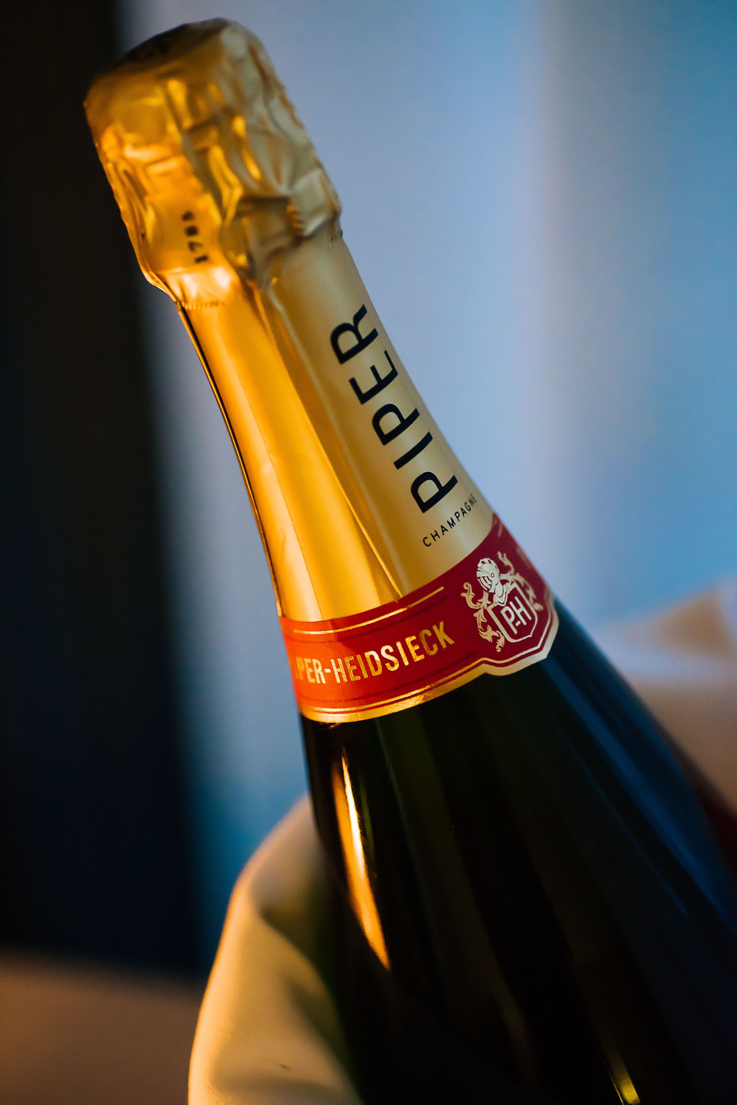 A bottle of Piper champagne with a label indicating it is from the Per-Heidsieck region.