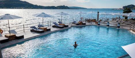 Seasonal outdoor pool, open 9:30 AM to 6:30 PM, pool umbrellas