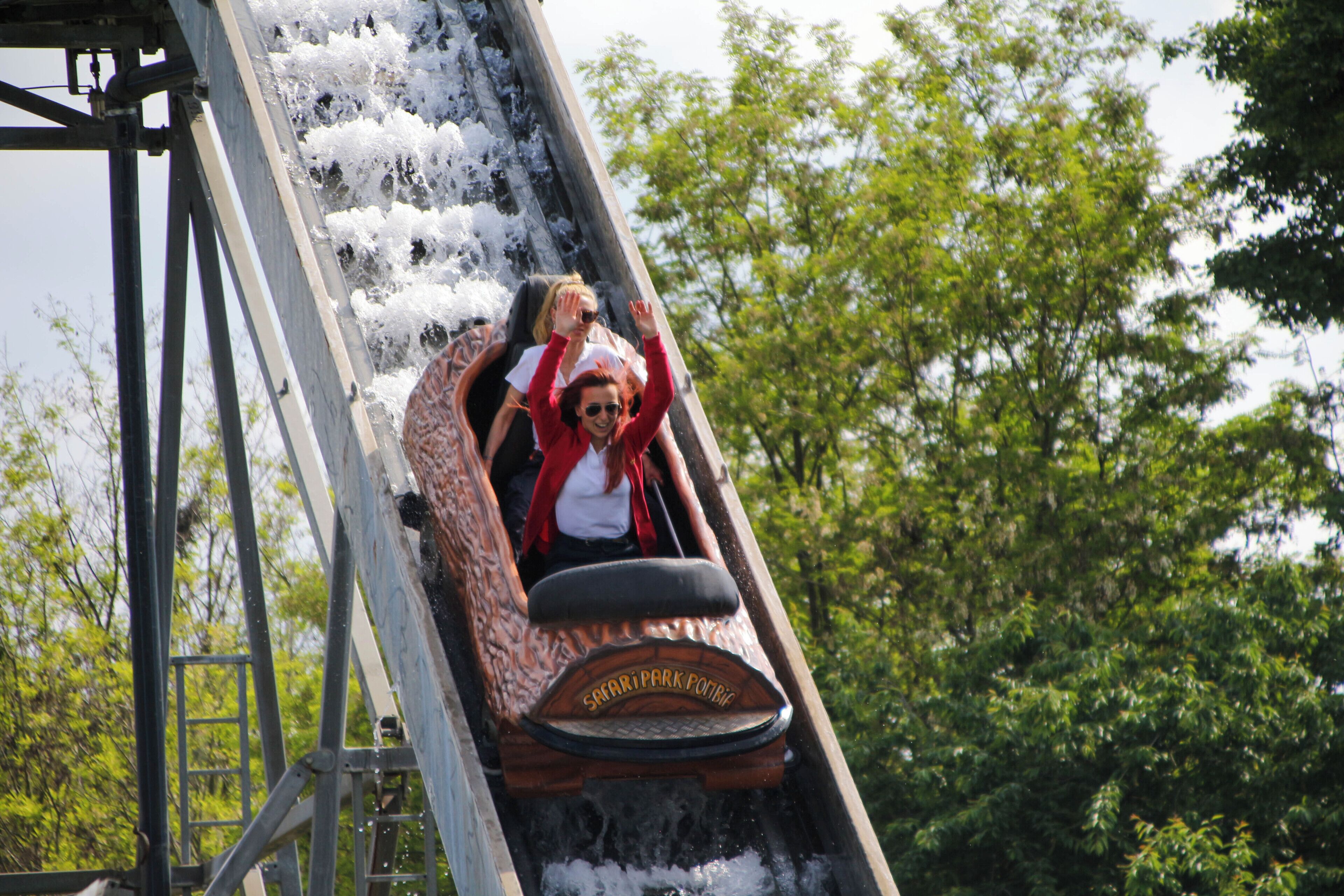 A wooden roller coaster with a sign reading "Safari Park Pottery" at the front.