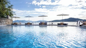 Seasonal outdoor pool, open 9:30 AM to 6:30 PM, pool umbrellas