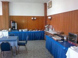 Enjoy meals in this cozy dining area with a long table and comfortable chairs.