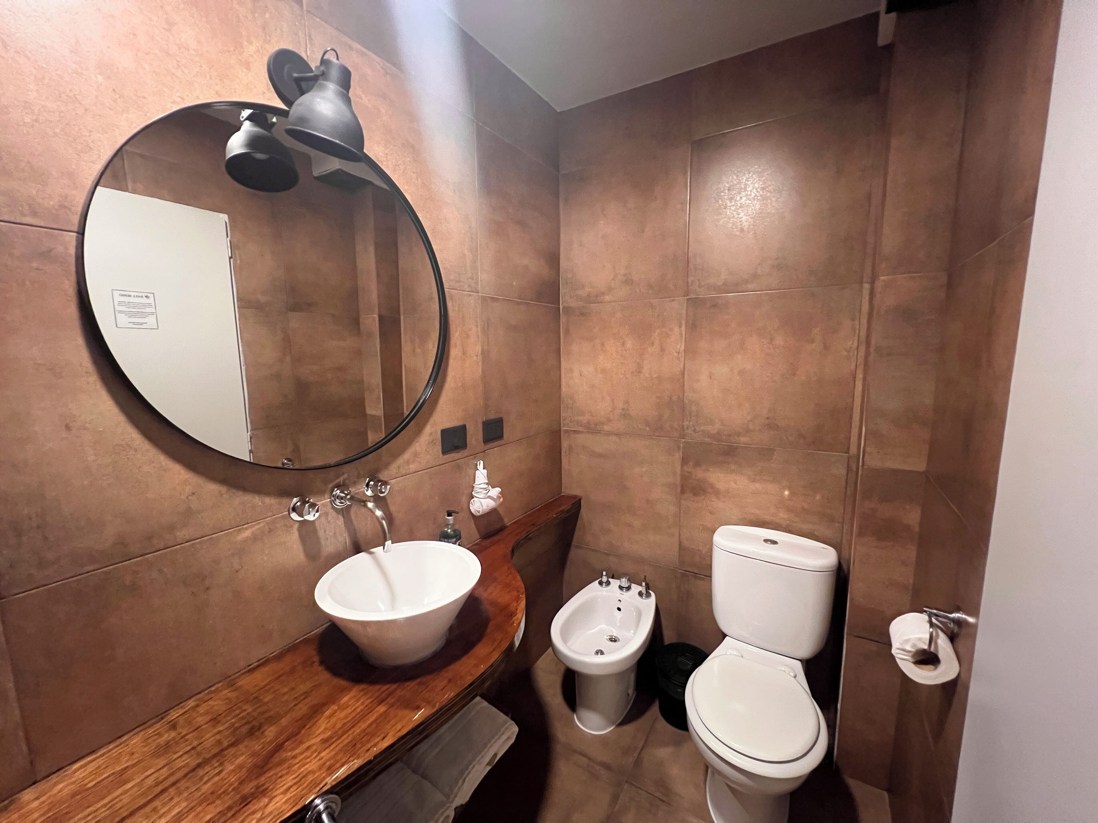 deluxe studio suite | bathroom | rainfall showerhead, free toiletries, hair dryer, bathrobes