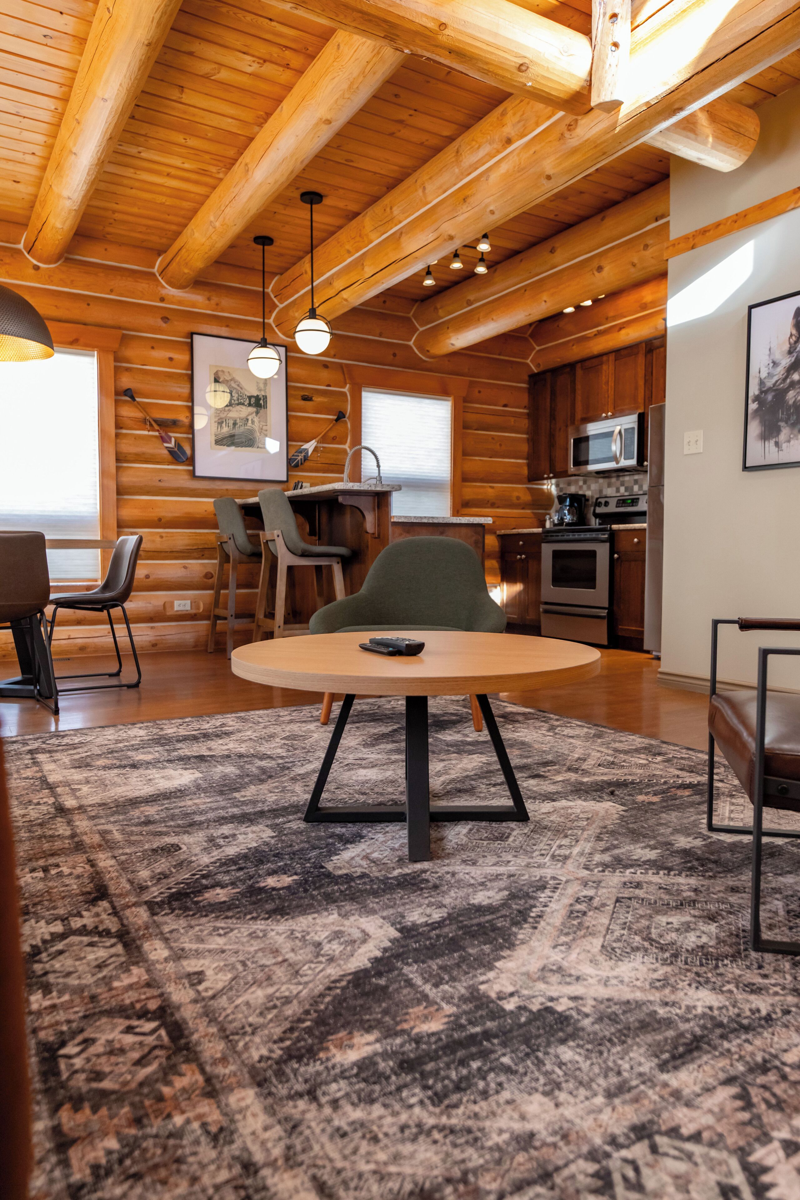 Ein Blockhaus-Interieur mit Essbereich, Küche und einer Bar.