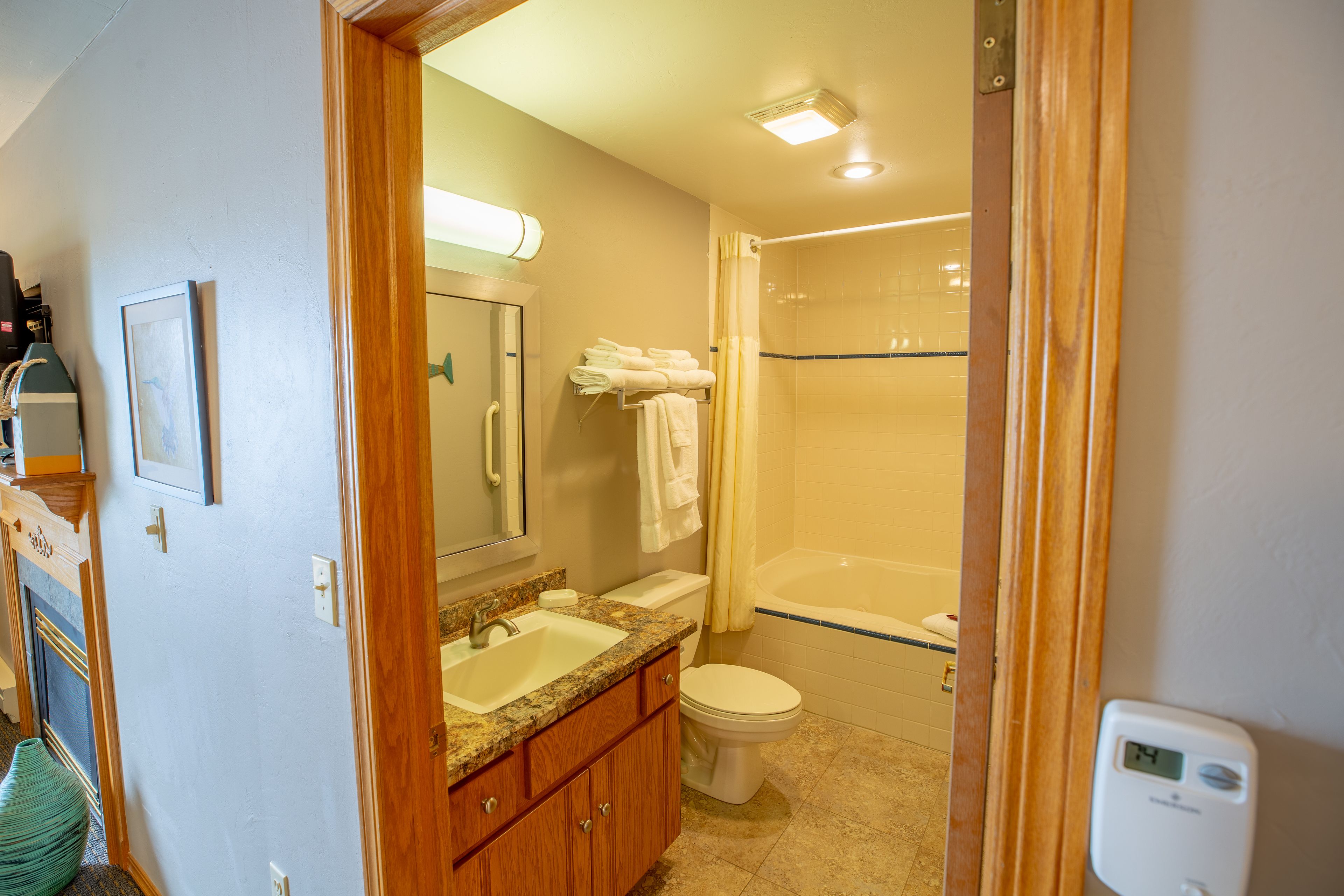 A bathroom with a sink, toilet, and shower.