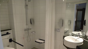 A modern bathroom with a shower, toilet, and sink. - Holiday Inn Express Colchester by IHG (Colchester)