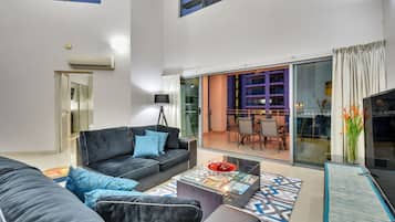 Premium Penthouse, 4 Bedrooms | Living area | 42-inch Smart TV with cable channels