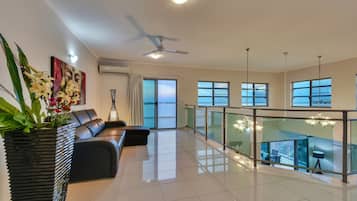 Premium Penthouse, 4 Bedrooms | Living area | 42-inch Smart TV with cable channels