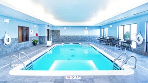 A swimming pool with a lifeguard chair, pool lift, and a sign indicating no diving. - Holiday Inn Express & Suites Elkton - University Area by IHG (Elkton)