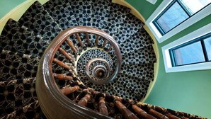 A spiral staircase with a patterned carpet and a metal railing. - Hotel Brexton, Trademark Collection by Wyndham (Baltimore)