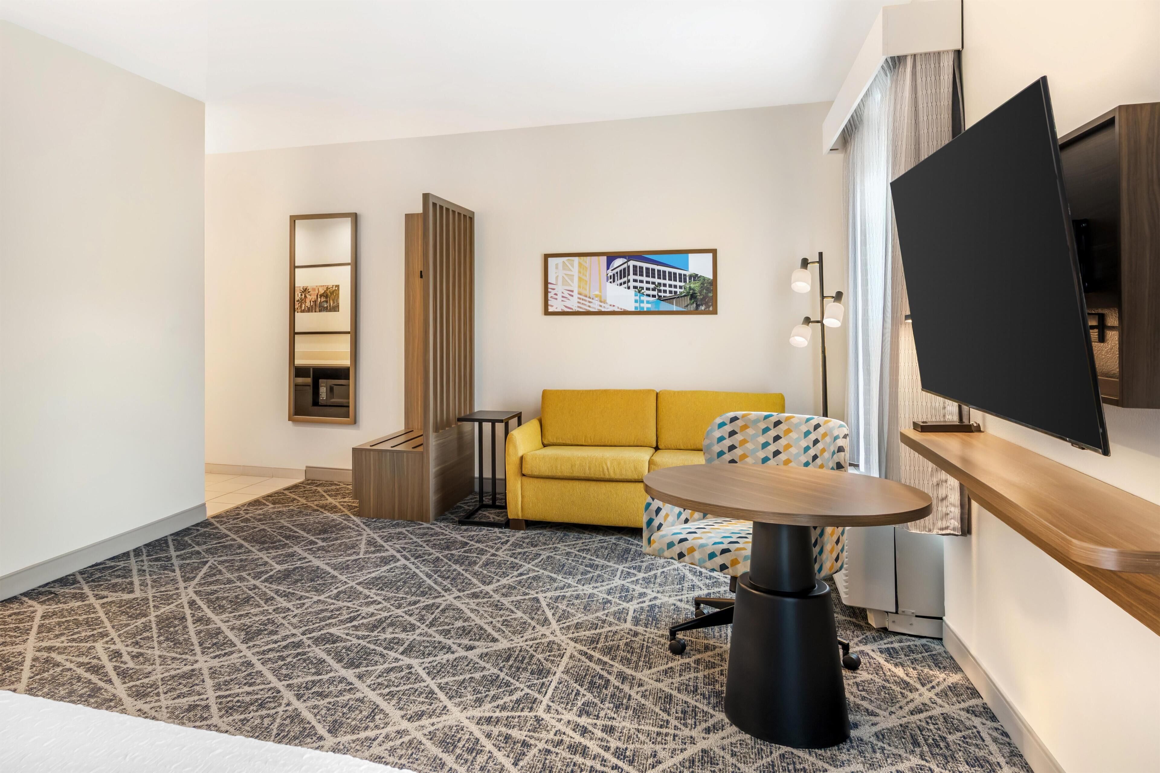 Studio Suite, 1 King Bed, Refrigerator & Microwave | Living area | 32-inch LCD TV with satellite channels, TV
