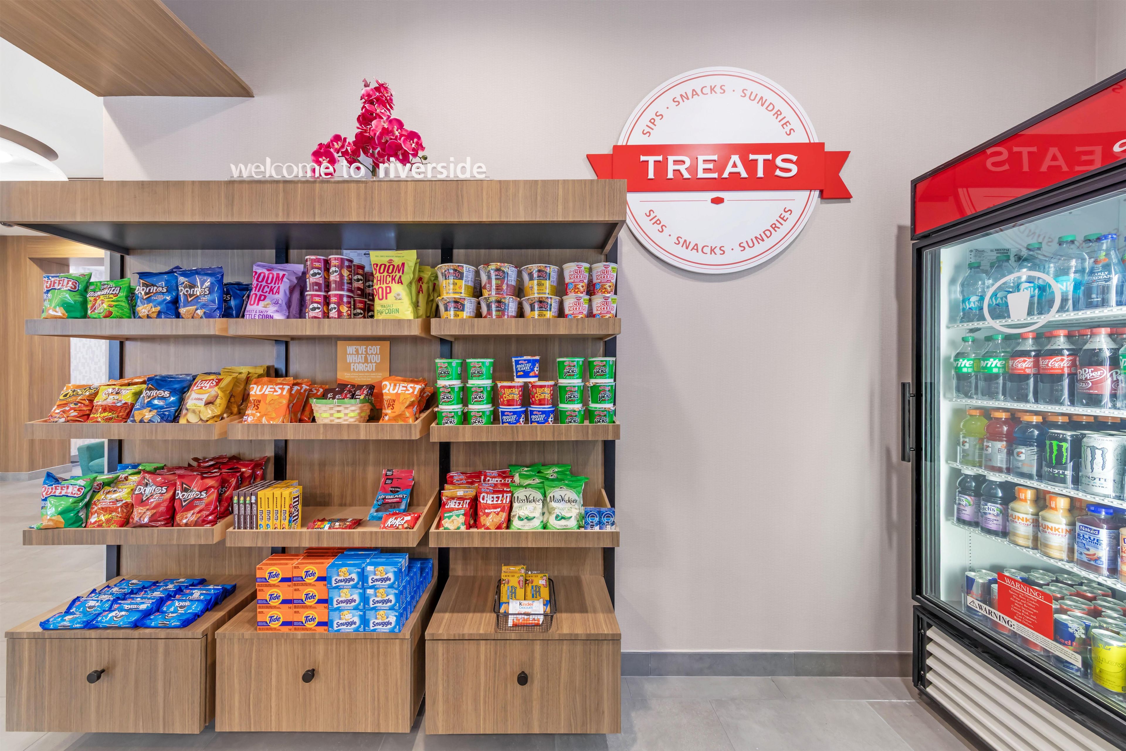A snack display with various chips, candies, and snacks.