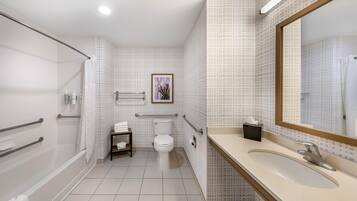 A modern bathroom with a shower, toilet, and sink.