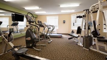 A gym with treadmills, elliptical machines, and weight machines.