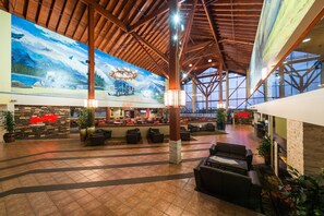 A spacious lobby with a high ceiling, large windows, and a mural depicting a mountainous landscape. - Super 8 by Wyndham Sherwood Park/Edmonton Area (Sherwood Park)