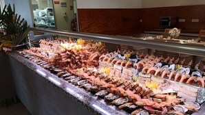 A seafood display with various types of seafood including shrimp, oysters, and fish. - Hotel Marina di Lava (Appietto)