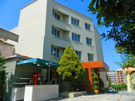 A multi-story building with a flat facade, large windows, and a Coca-Cola sign on the ground floor.