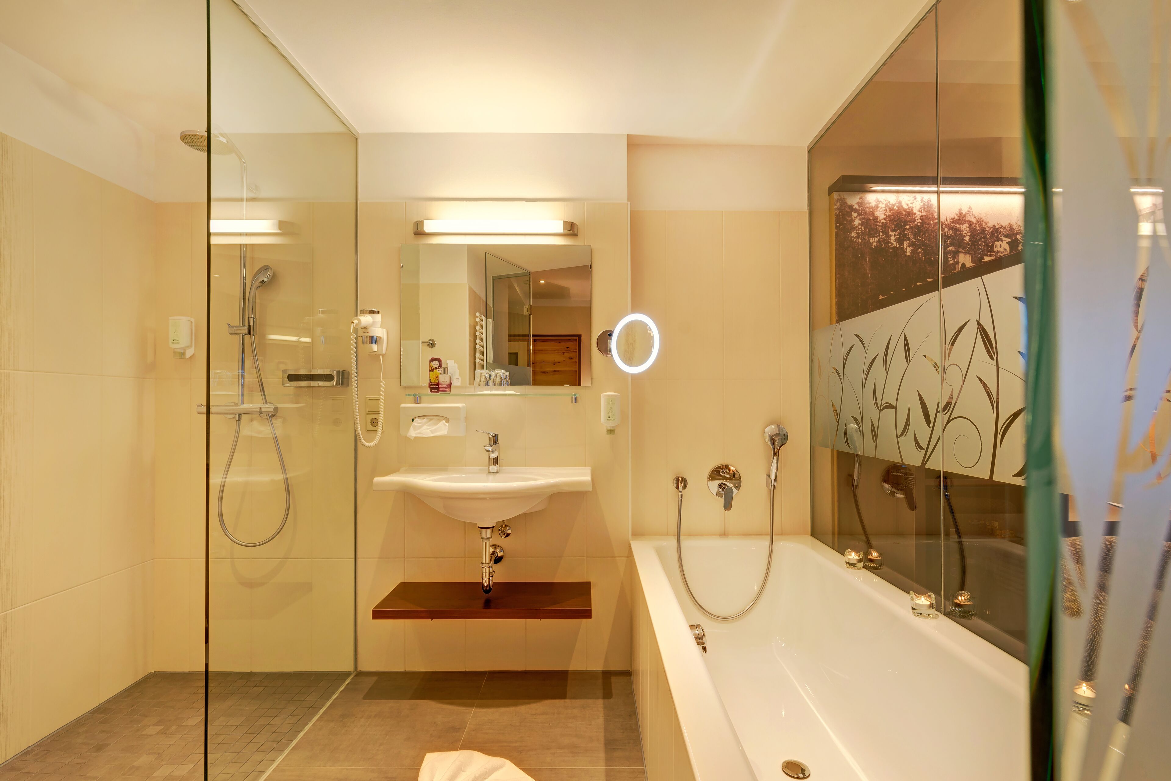 A modern bathroom with a glass-enclosed shower, a sink, and a bathtub.