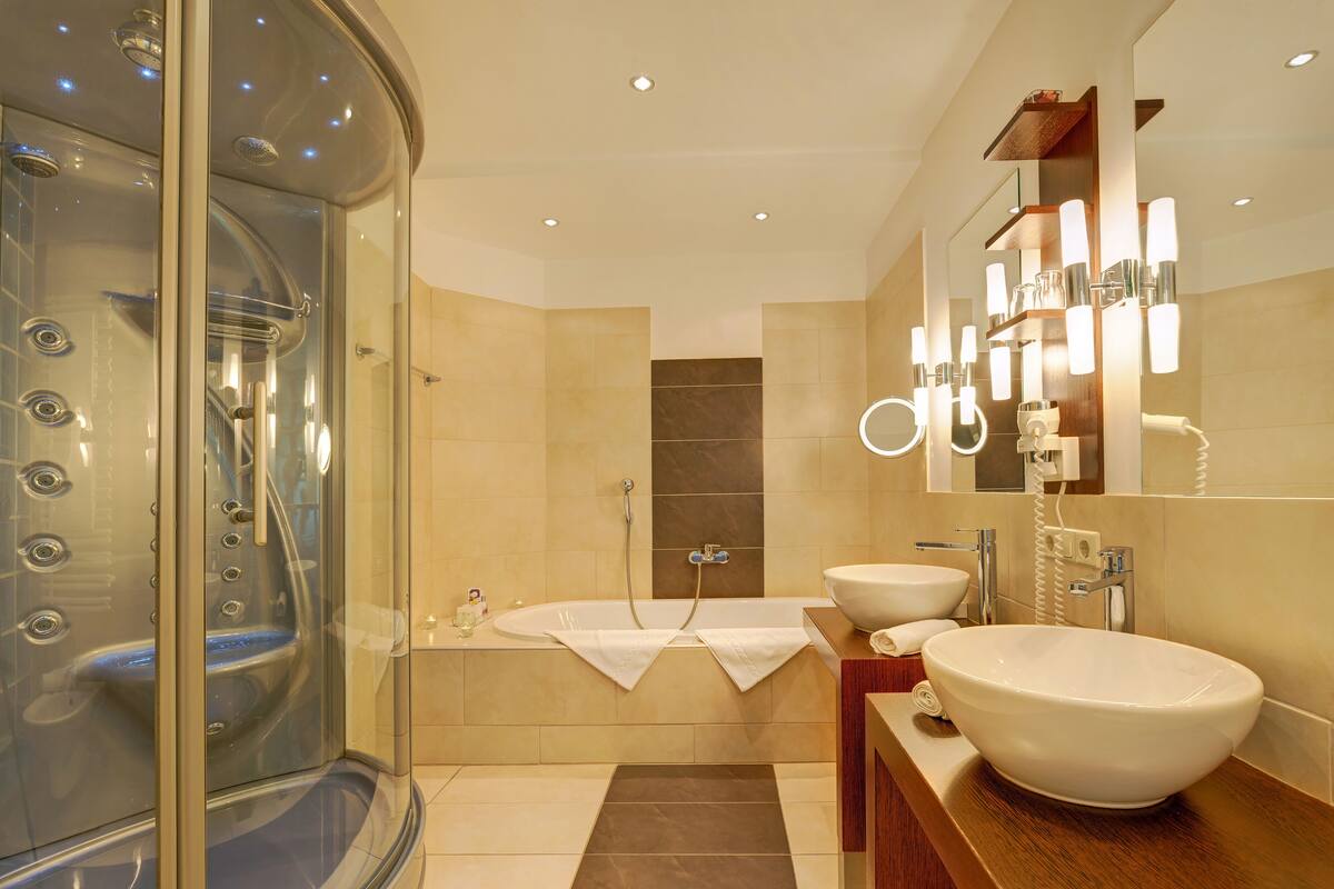 junior suite | bathroom | shower, hair dryer, bathrobes, slippers